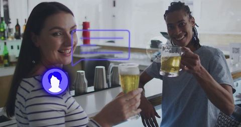 Friends Clinking Beer Glasses at Bright Bar Counter Celebrating Toast and Conversation