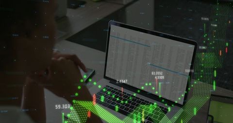 Woman reviewing trading data on laptop with candlestick charts and smartphone