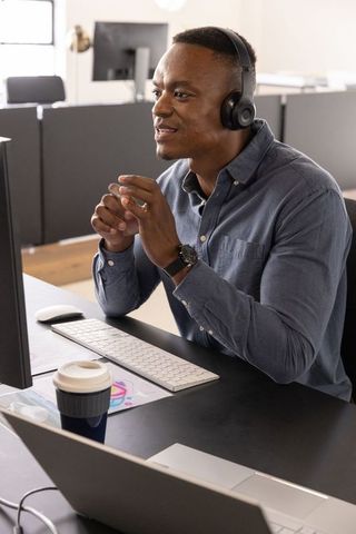 Professional Man Communicating via Headset in Modern Office