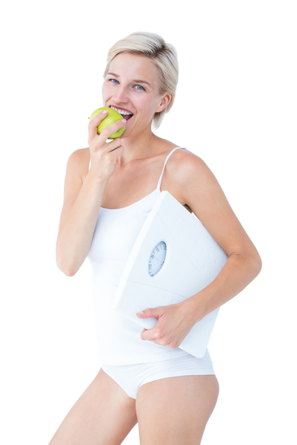 Healthy Woman Eating Green Apple While Holding Transparent Scales - Download Free Stock Videos Pikwizard.com