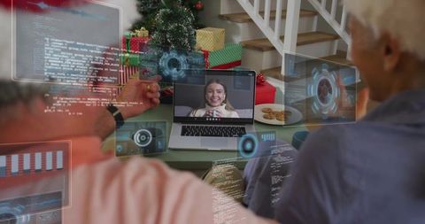 Multigenerational family video calling at christmas with laptop, gifts and futuristic hud overlays