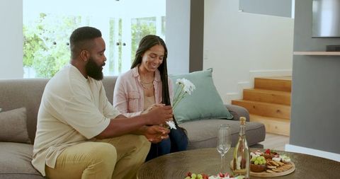 Happy Couple Celebrating with Gift Exchange at Home