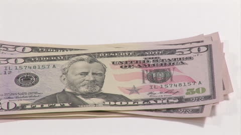 Stack of Fifty Dollar Bills Isolated on White Background