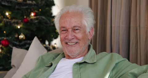 Senior Man Relaxing at Home During Christmas Holiday Season