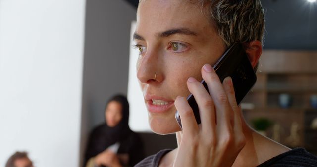 Woman with Short Hair Talking on Smartphone in Modern Home - Download Free Stock Images Pikwizard.com