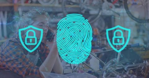 Mechanic calling phone while biometric fingerprint and security icons overlaying workshop
