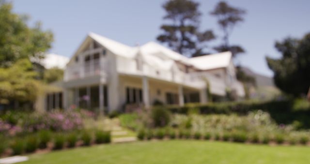 Defocused view of large luxury house exterior and sunny garden. Property, home, luxury, summer and lifestyle, unaltered.