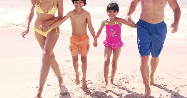 Happy family walking together on a sandy beach, holding hands and enjoying a summer vacation. Ideal for use in travel advertisements, family-life articles, summer promos, and vacation brochures.
