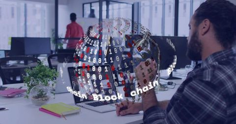 Developer working with holographic blockchain globe over laptop in modern open office