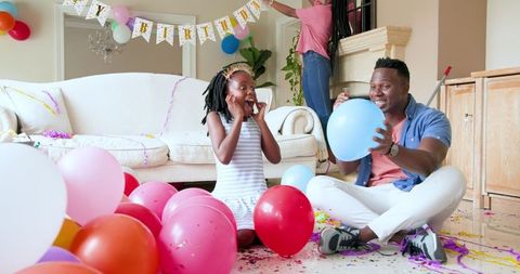 Family Celebrating Daughter's Birthday at Home Filled with Joyful Balloons