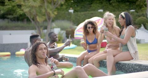 Diverse Group of Young Adults Relaxing at Outdoor Pool Party