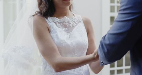 Bride Holding Groom's Hands During Romantic Wedding Ceremony