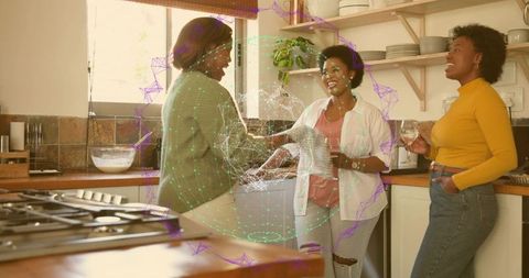 Three midadult women chatting in cozy kitchen holding glasses around holographic data sphere
