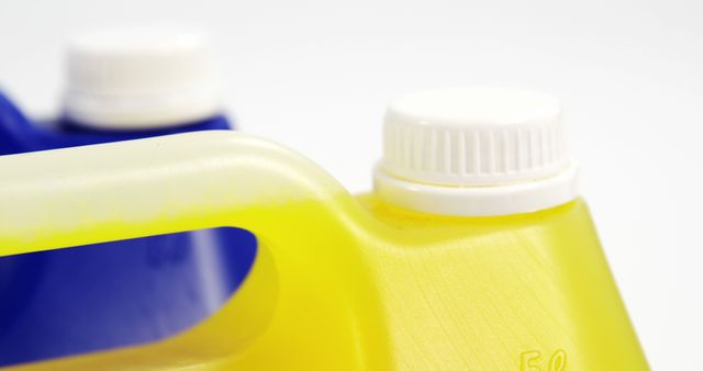 Image depicts close-up view of two colorful plastic containers with white caps, emphasizing their textures and colors. Ideal for use in industrial, storage, and household contexts depicting packaging, organization, and convenience aspects. Effective in materials aiming to showcase eco-friendly storage solutions, manufacturing quality, or product design.