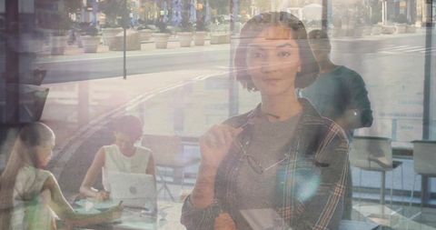 Confident woman in modern cafe with team collaborating