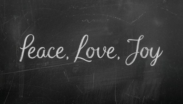 Chalkboard handlettered peace love joy featuring chalk dust and weathered texture