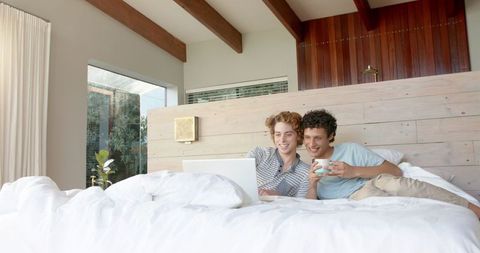 Couple Relaxing in Bedroom Engaging with Laptop for Leisure - Download Free Stock Images Pikwizard.com