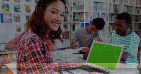 Diverse students studying with laptop in library learning environment