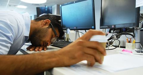 Exhausted Office Worker Resting at Busy Workspace - Download Free Stock Images Pikwizard.com