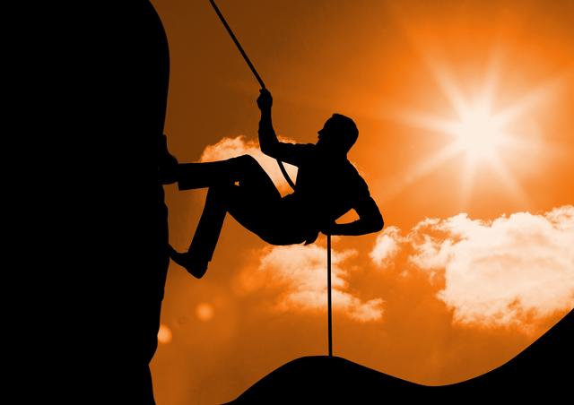 Digital composition of silhouette man climbing a mountain against sunny background