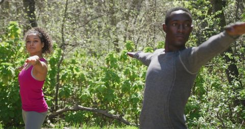 Diverse Couple Practicing Yoga Outdoors in Nature