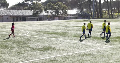 Youth soccer players setting up free kick