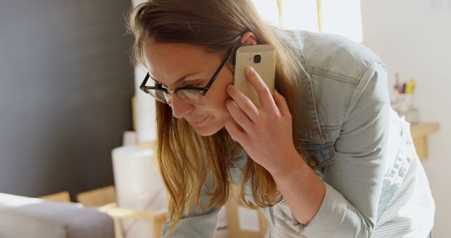 Young Woman Talking on Mobile Phone in Home Office - Download Free Stock Images Pikwizard.com