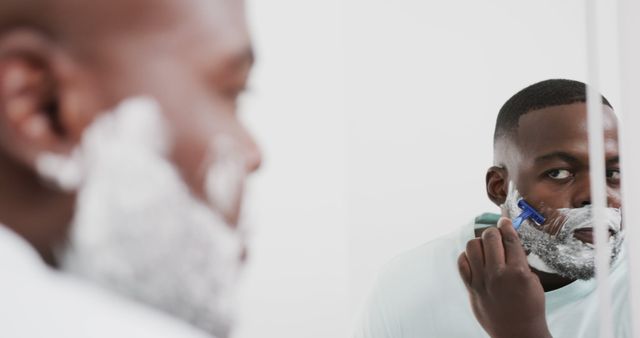 Man Shaving Beard with Razor in Mirror Reflection - Download Free Stock Images Pikwizard.com