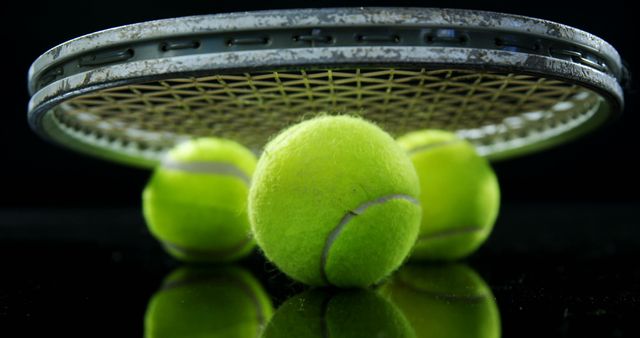 Close-Up of Tennis Racket and Balls on Black Background - Download Free Stock Images Pikwizard.com