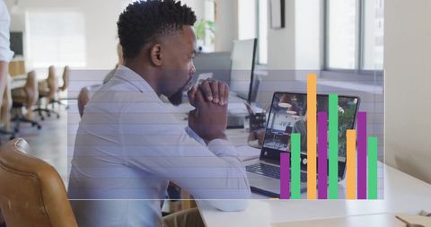 Businessman Analyzing Data During Virtual Meeting in Modern Office