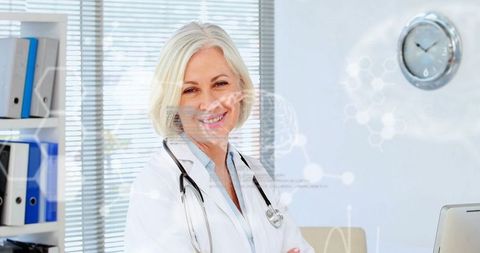 Senior Female Doctor Embracing Medical Technology in Modern Office