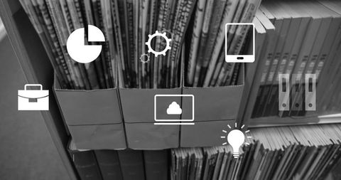Organizing periodicals in cardboard holders displaying cloud laptop, lightbulb, folder icons