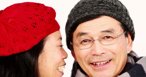 Middle-Aged Asian Couple Smiling in Cozy Winter Attire