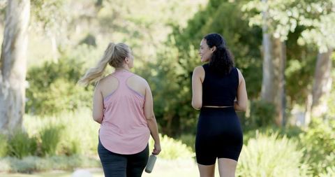Diverse Friends Enjoying Fitness Walk in Sunny Park