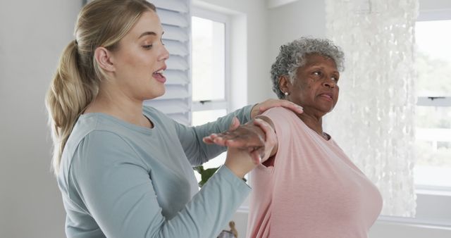 Physiotherapist Assisting Elderly Woman with Arm Rehabilitation Exercises - Download Free Stock Images Pikwizard.com