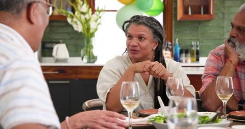 Senior friends sharing wine and celebrating friendship