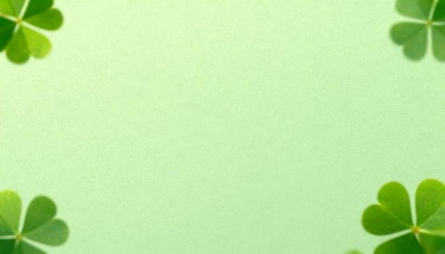 Framing four-leaf clovers around textured green backdrop for st patrick's day minimalist