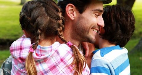 Smiling Soldier Reunites with Children in Sunny Park - Download Free Stock Images Pikwizard.com