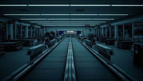 Leading Symmetrical Checkout Conveyors Guiding Gaze Through Blue Fluorescent Retail Interior