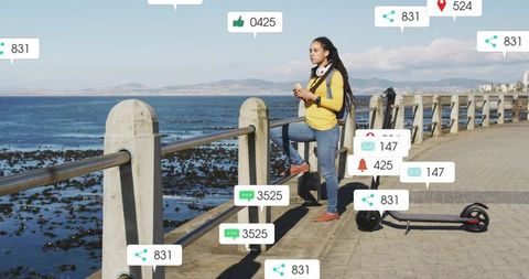 Young woman standing on coastal promenade with electric scooter and social media overlays