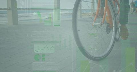 Cyclist riding seaside path with data overlay and stunning view
