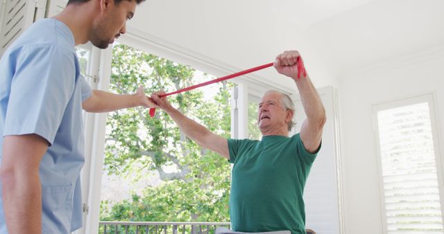 Senior Man Working with Physical Therapist Using Resistance Band for Rehabilitation - Download Free Stock Images Pikwizard.com