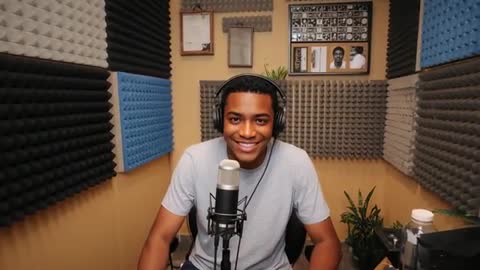 Black Podcaster Recording in Home Studio Booth with Headphones and Condenser Microphone