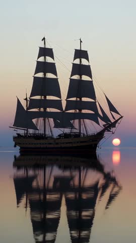 Vertical Tall Ship Sailing at Pastel Sunset with Mirror Reflection on Calm Sea