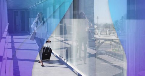 Businesswoman Walking with Luggage in Modern Airport Hallway