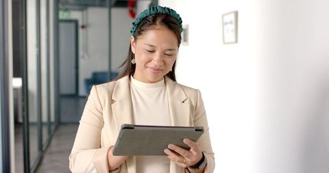 Confident Woman Using Tablet in Modern Corporate Office