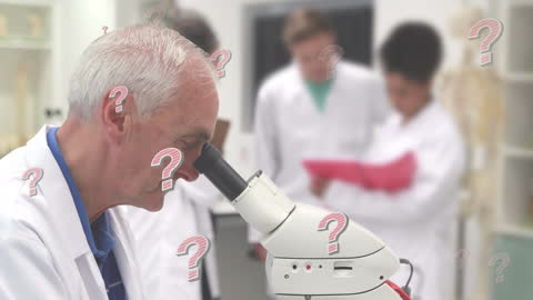 Pensive Senior Scientist Examining Specimen Under Microscope