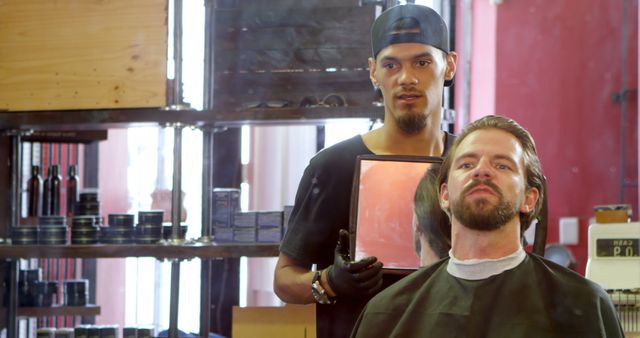 Barber holding mirror for customer to view haircut, highlighting professional grooming and hair care services. Ideal for use in advertisements for barber shops, grooming products, and lifestyle blogs. Can be utilized to showcase customer satisfaction and professional barbering skills.