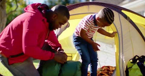 Father and Son Bonding While Setting Up Backyard Tent
