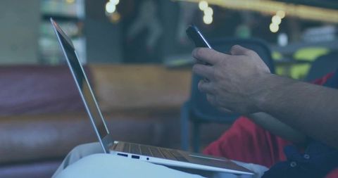 Multitasking with Laptop and Smartphone in Modern Lounge Area